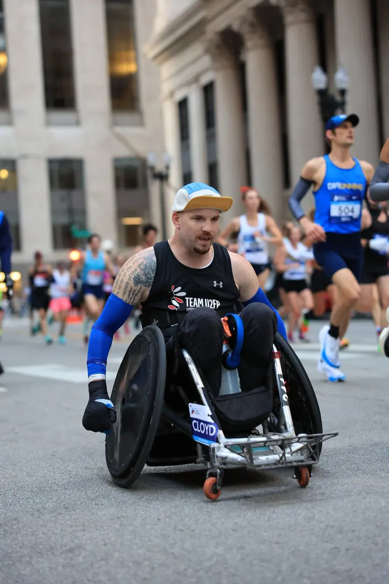 Thomas mid-push on a downtown Chicago street, race number visible